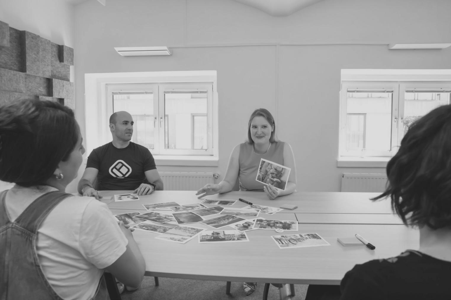 Financial planning session with charts and documents spread across a conference table